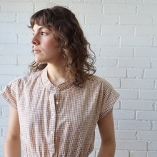 Load image into Gallery viewer, Woman wearing a checkered shirt against a white brick wall