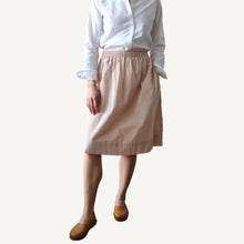 Load image into Gallery viewer, Person wearing a white shirt and beige checkered skirt on a plain background