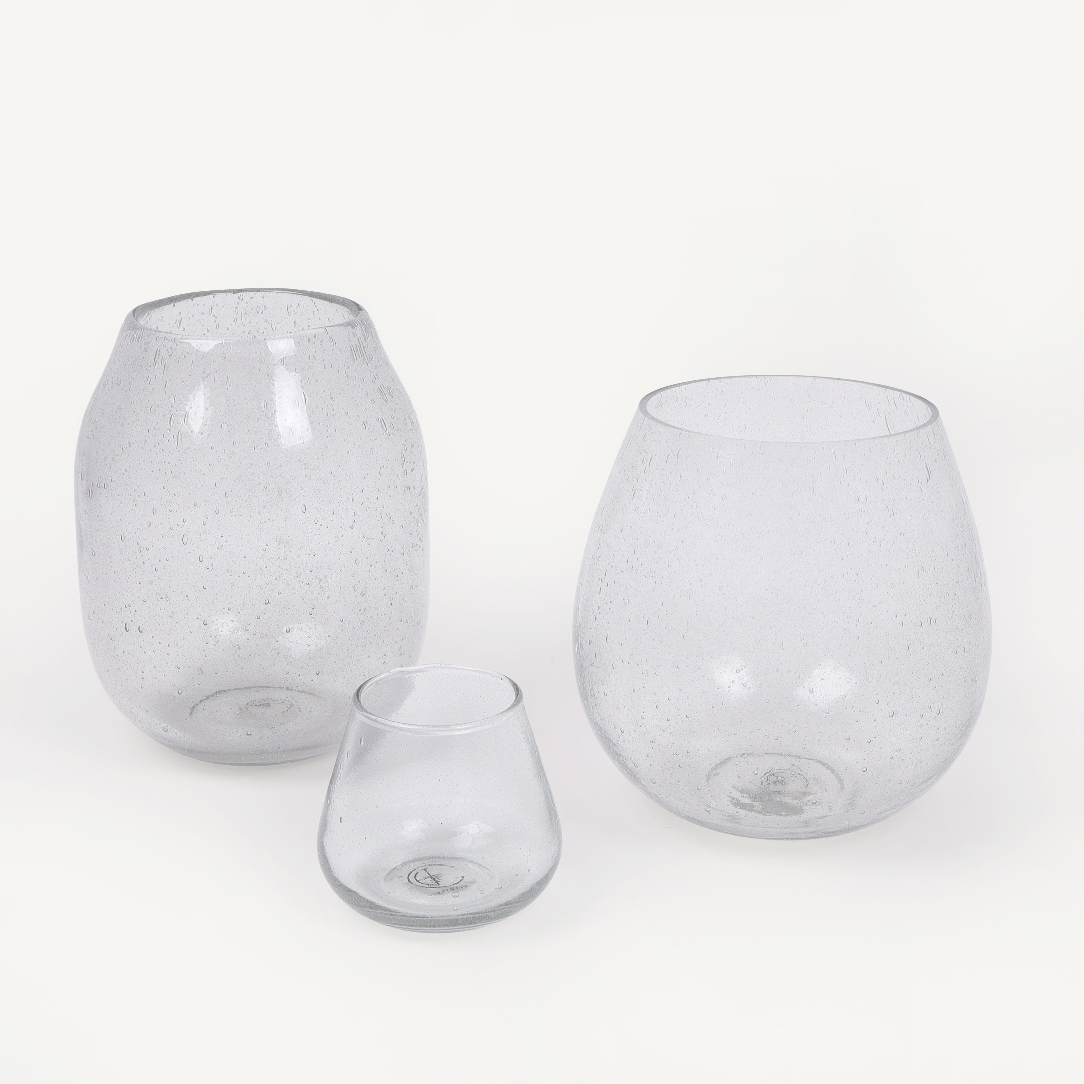 Three clear glass vase of different sizes on a white background