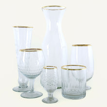 Load image into Gallery viewer, Set of clear glassware with gold rims on a white background
