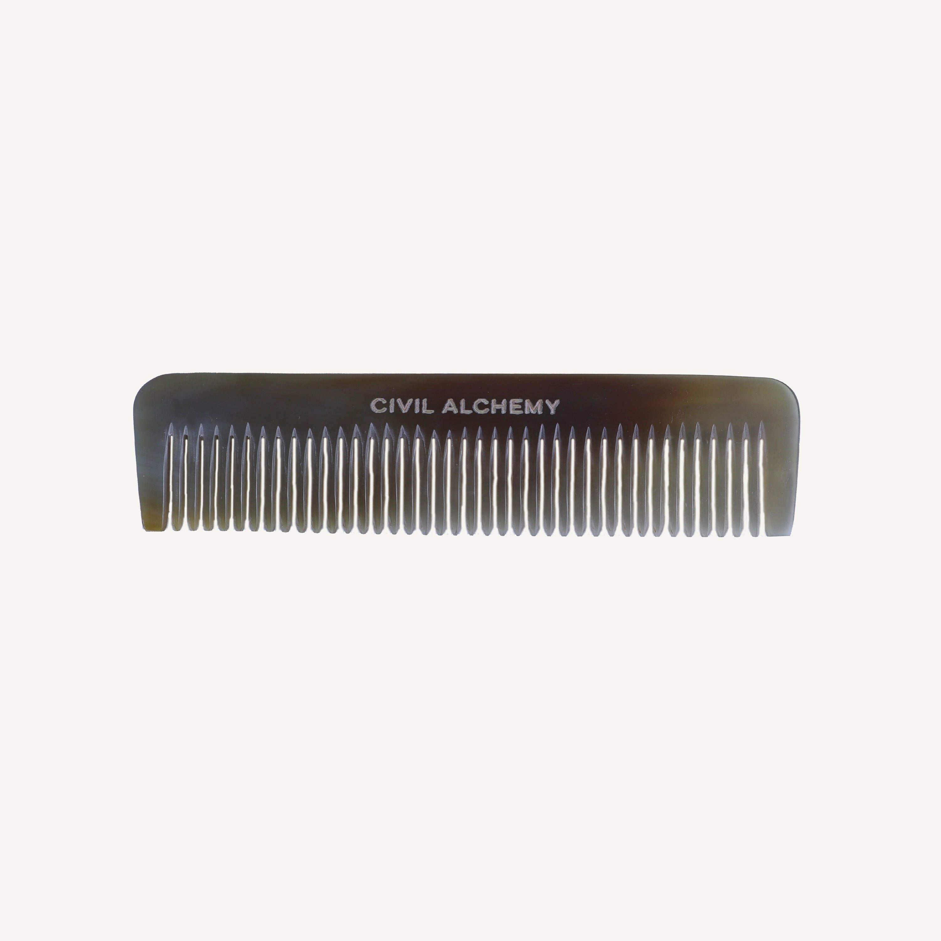 Comb with 'Civil Alchemy' branding on a white background