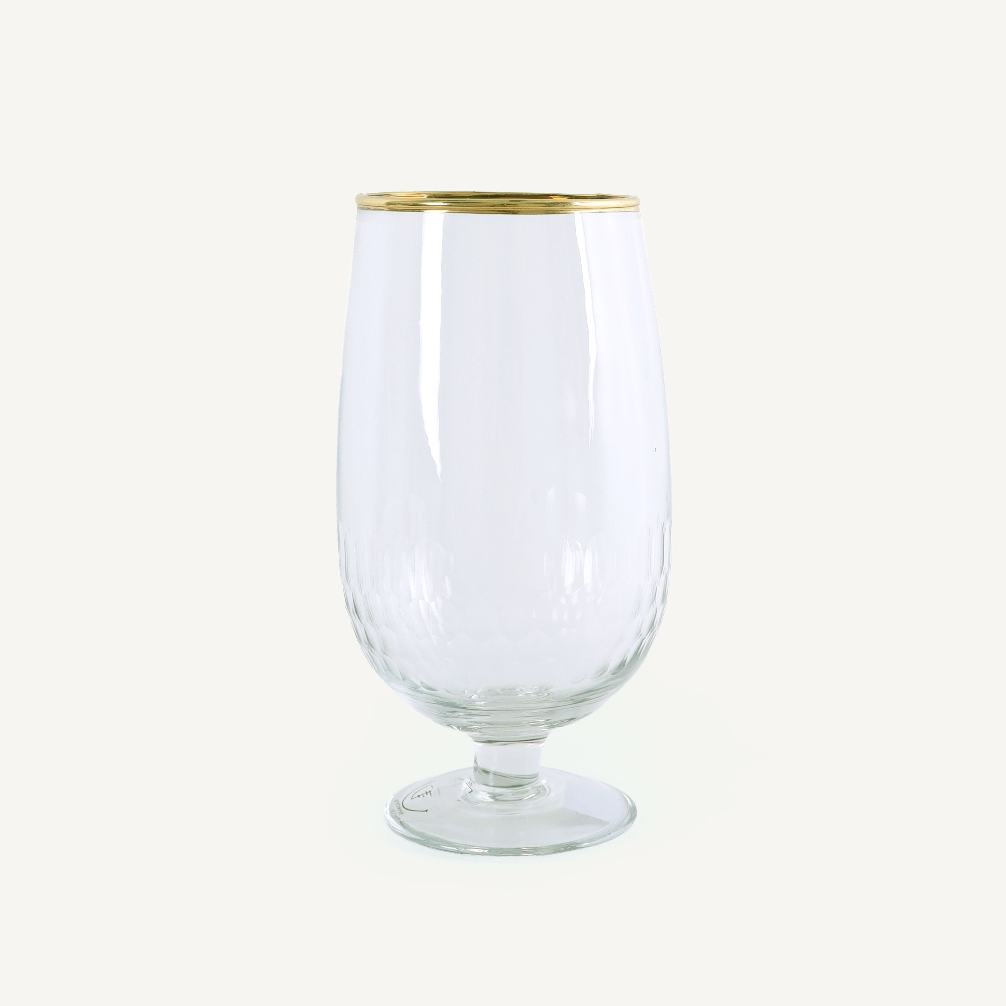 Clear glass with gold rim on a white background