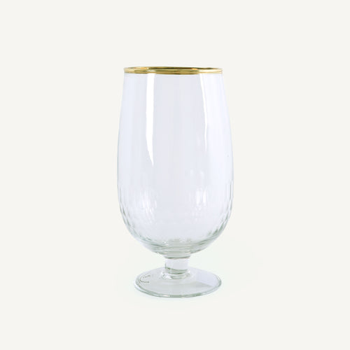 Clear glass with gold rim on a white background