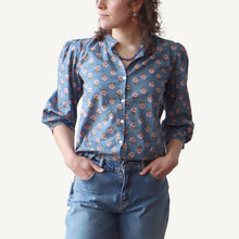 Load image into Gallery viewer, Person wearing a blue floral shirt and jeans on a white background
