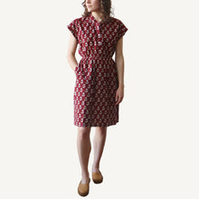 Load image into Gallery viewer, Woman wearing a red patterned dress on a white background
