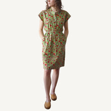 Load image into Gallery viewer, Woman wearing a green floral dress on a white background
