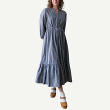 Load image into Gallery viewer, Woman wearing a blue and white checkered dress on a plain background
