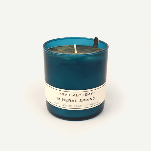 Blue candle with a label on a white background