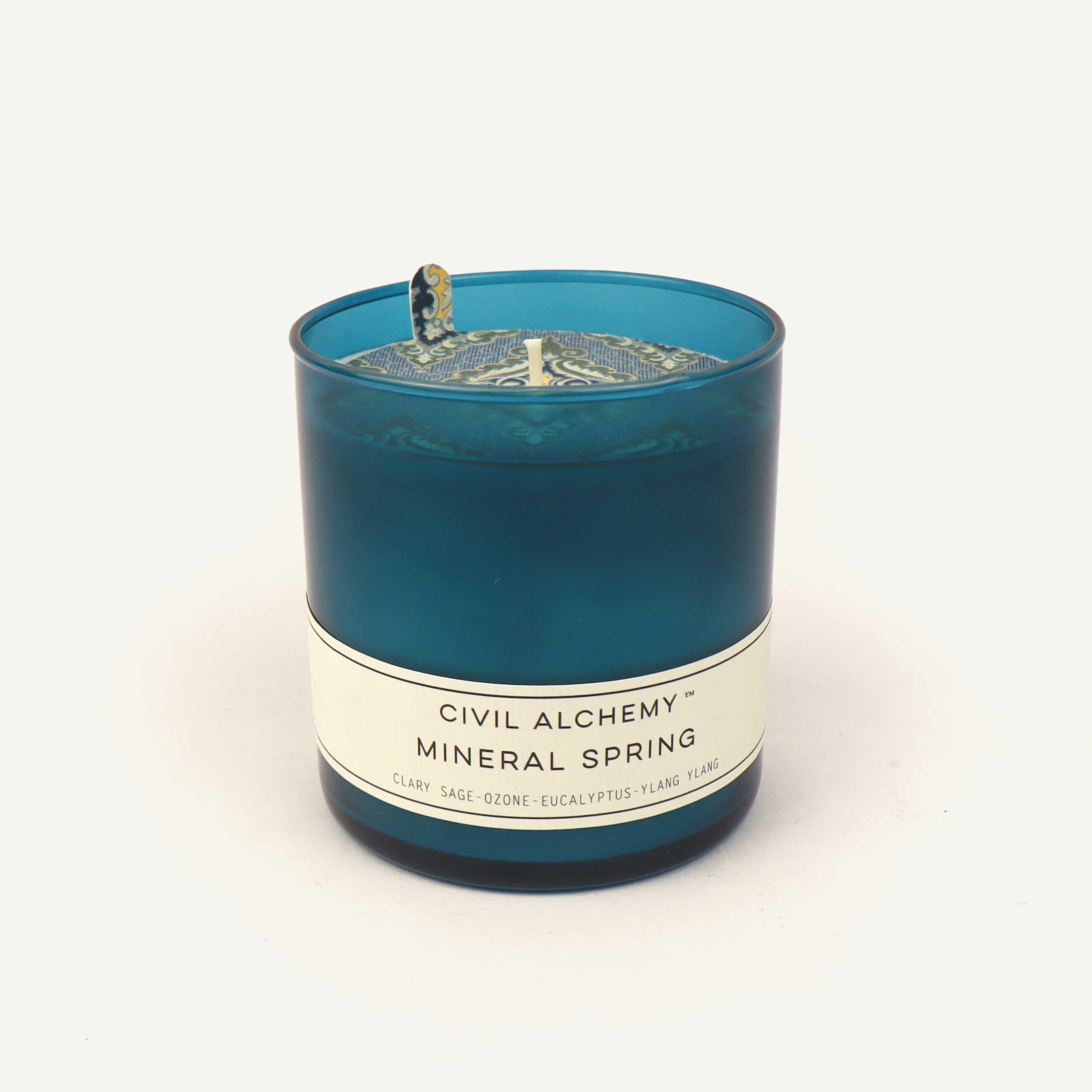 Blue candle with a label on a white background