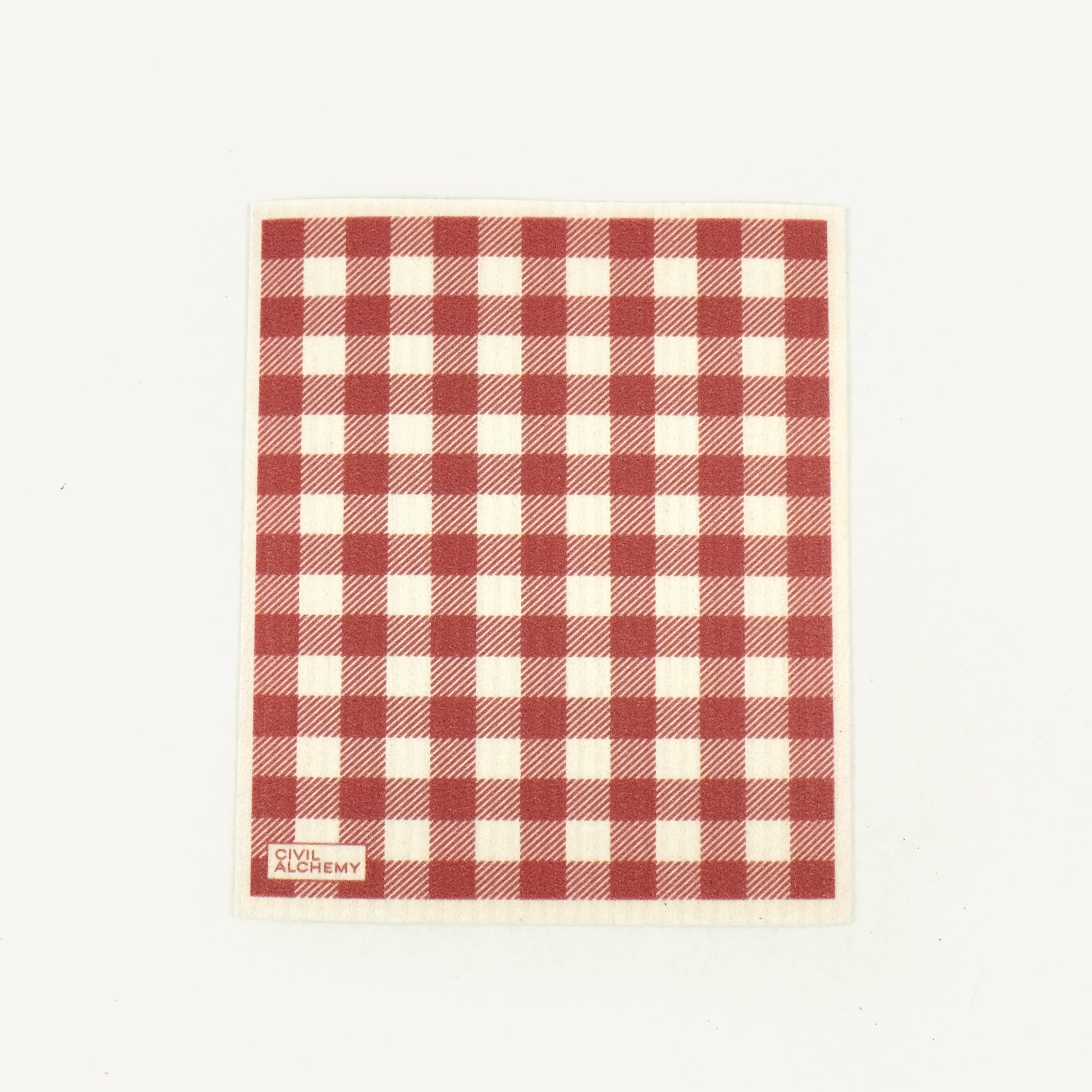 Red and white checkered towel with 'Civil Alchemy' branding on a light beige background