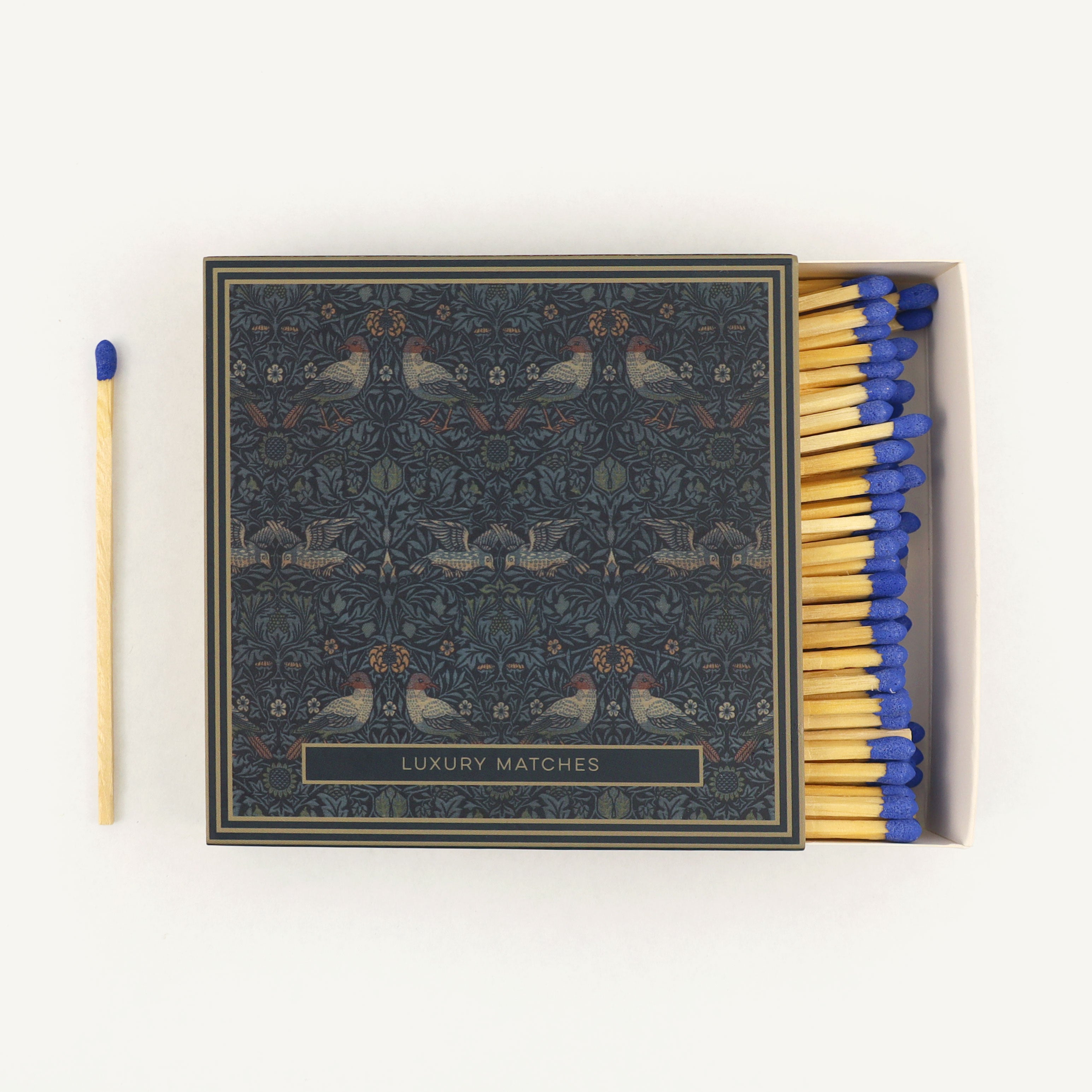 Box of matches with decorative design and 'Luxury Matches' text on a white background